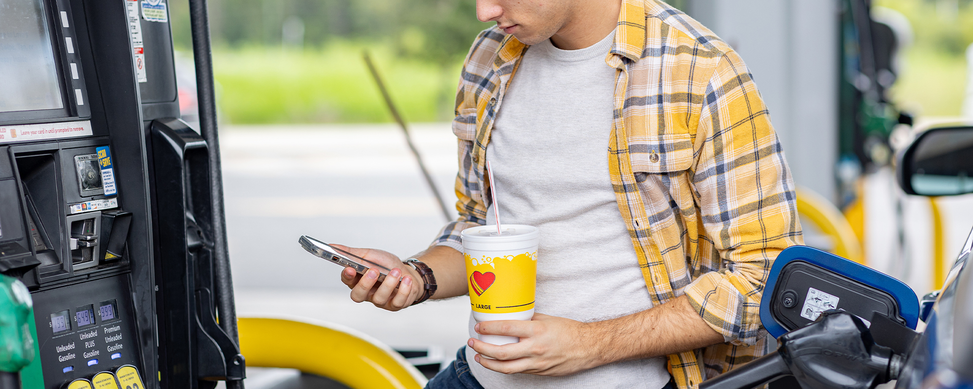 A customer on their phone pumping gas at a Love's