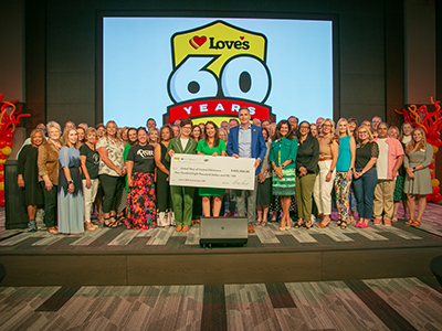 Love's Chief Culture Officer, Jenny Meyer Love, and President, Shane Wharton, with United Way agency representatives and a donation check of 408,000