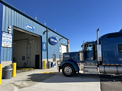 A truck pulled up to a Truck Wash bay at a Love's Travel Stop