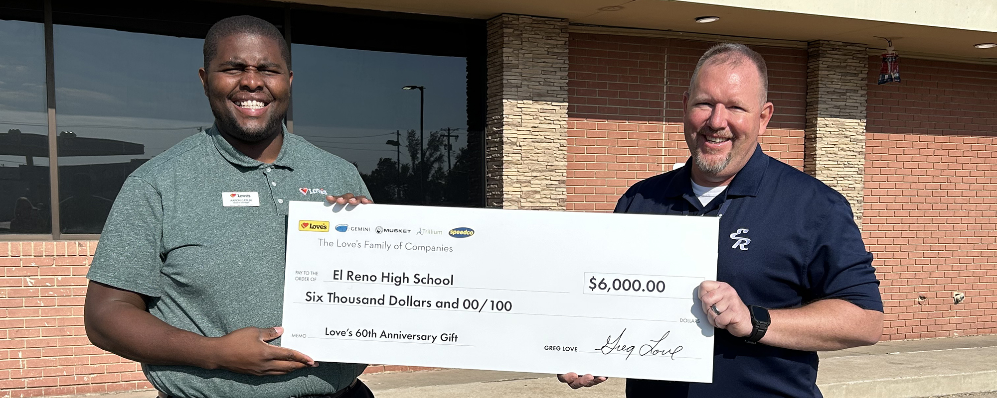 Love's GM pictured with a donation check with El Reno principal