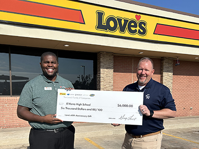 Love's GM pictured with a donation check with El Reno principal